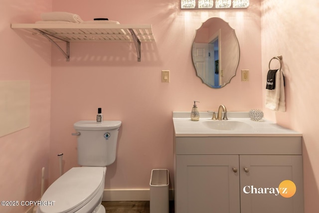 799 8th Ave, Fairbanks, AK 99701 - half bathroom with toilet, vanity, baseboards, and wood finished floors