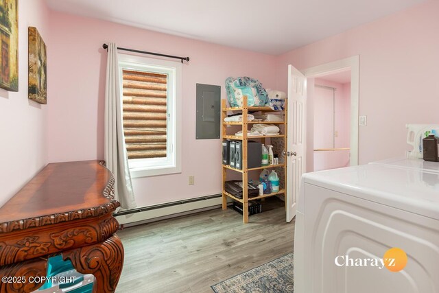 799 8th Ave, Fairbanks, AK 99701 - laundry room with a baseboard heating unit, washer / clothes dryer, electric panel, and light wood-style flooring