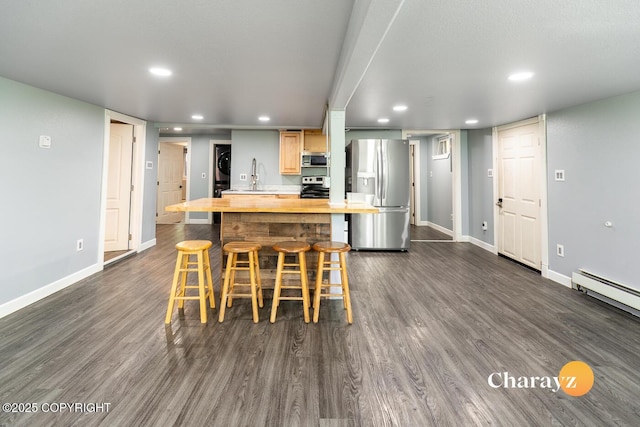 799 8th Ave, Fairbanks, AK 99701 - kitchen featuring appliances with stainless steel finishes, butcher block countertops, recessed lighting, a kitchen breakfast bar, and baseboards