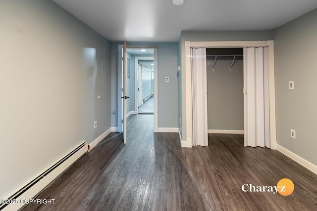 799 8th Ave, Fairbanks, AK 99701 - unfurnished bedroom with a baseboard radiator, dark wood-style flooring, baseboards, and a closet