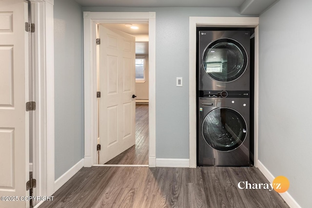 799 8th Ave, Fairbanks, AK 99701 - laundry room with estacked washer and dryer, wood finished floors, baseboards, and baseboard heating