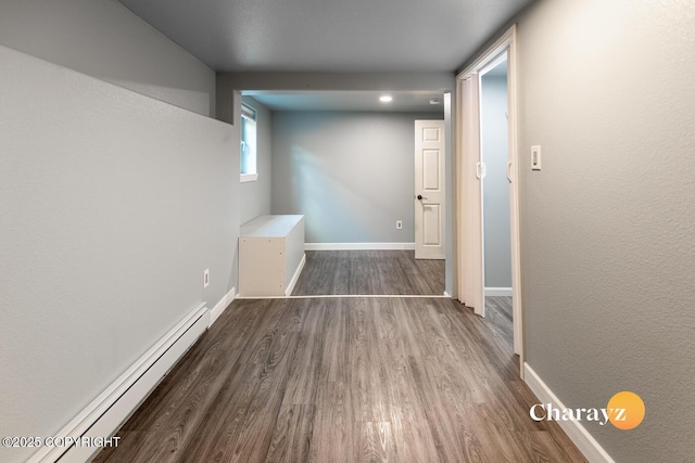 799 8th Ave, Fairbanks, AK 99701 - hall featuring baseboard heating, wood finished floors, and baseboards