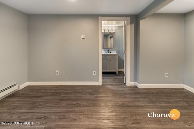 799 8th Ave, Fairbanks, AK 99701 - spare room featuring dark wood-style flooring, baseboards, and a sink