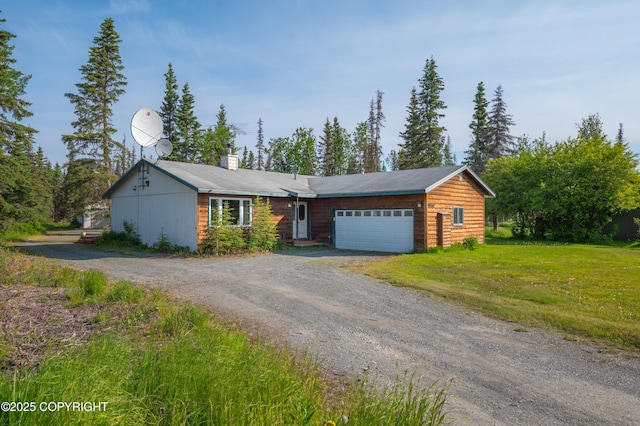 48160 Snowflake Ct, Soldotna, AK 99669 - view of front facade with dirt driveway, a chimney, an attached garage, and a front lawn