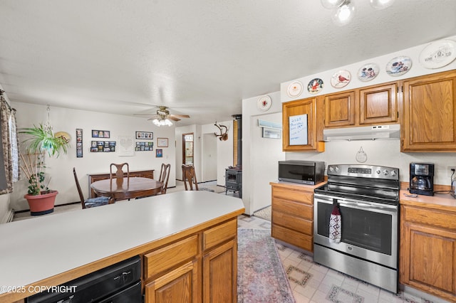 48160 Snowflake Ct, Soldotna, AK 99669 - kitchen featuring appliances with stainless steel finishes, under cabinet range hood, light countertops, ceiling fan, and a textured ceiling