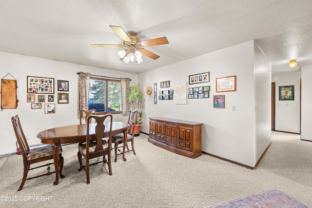 48160 Snowflake Ct, Soldotna, AK 99669 - dining room featuring light colored carpet, a ceiling fan, and a textured ceiling