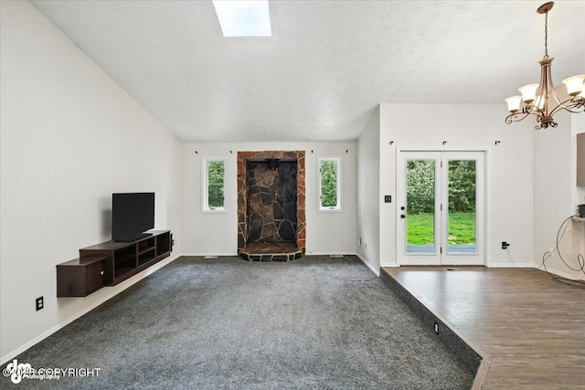 1940 E Caribou Loop, Wasilla, AK 99654 - unfurnished living room with a chandelier, wood finished floors, and a textured ceiling
