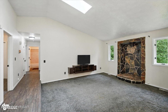 1940 E Caribou Loop, Wasilla, AK 99654 - unfurnished living room featuring lofted ceiling, carpet, and a stone fireplace