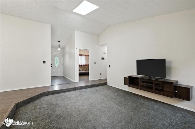 1940 E Caribou Loop, Wasilla, AK 99654 - unfurnished living room with vaulted ceiling, a skylight, and wood finished floors