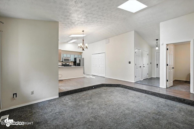1940 E Caribou Loop, Wasilla, AK 99654 - unfurnished living room featuring lofted ceiling, a chandelier, a textured ceiling, and dark colored carpet