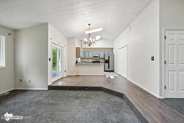 1940 E Caribou Loop, Wasilla, AK 99654 - foyer with a chandelier, vaulted ceiling, dark wood-style floors, and a textured ceiling