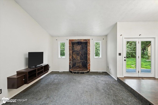 1940 E Caribou Loop, Wasilla, AK 99654 - unfurnished living room featuring carpet floors and a fireplace
