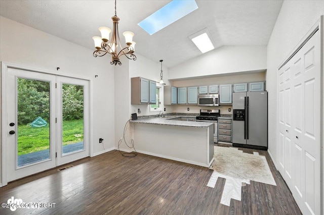 1940 E Caribou Loop, Wasilla, AK 99654 - kitchen featuring stainless steel appliances, a peninsula, a chandelier, dark wood-type flooring, and gray cabinetry