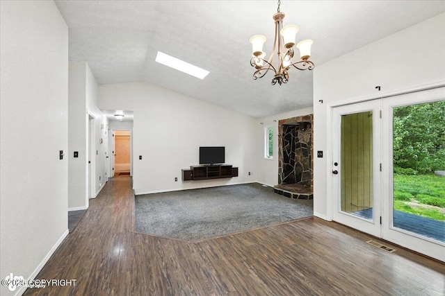 1940 E Caribou Loop, Wasilla, AK 99654 - unfurnished living room with dark wood finished floors, lofted ceiling, a chandelier, and a skylight