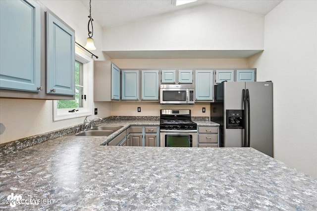 1940 E Caribou Loop, Wasilla, AK 99654 - kitchen featuring appliances with stainless steel finishes, lofted ceiling, pendant lighting, and dark countertops