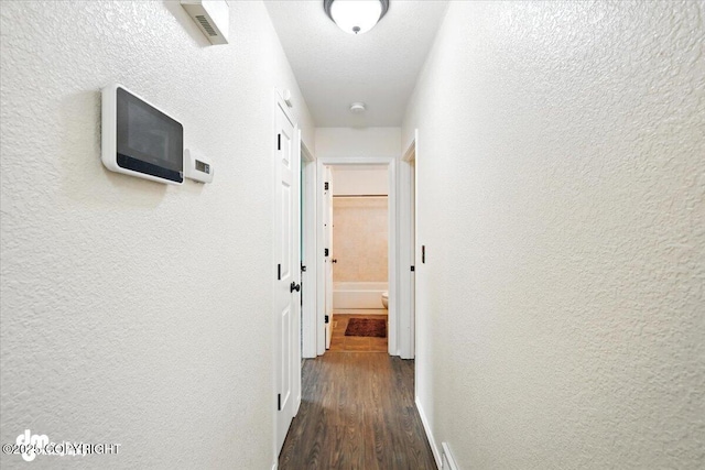 1940 E Caribou Loop, Wasilla, AK 99654 - corridor featuring a textured wall and wood finished floors