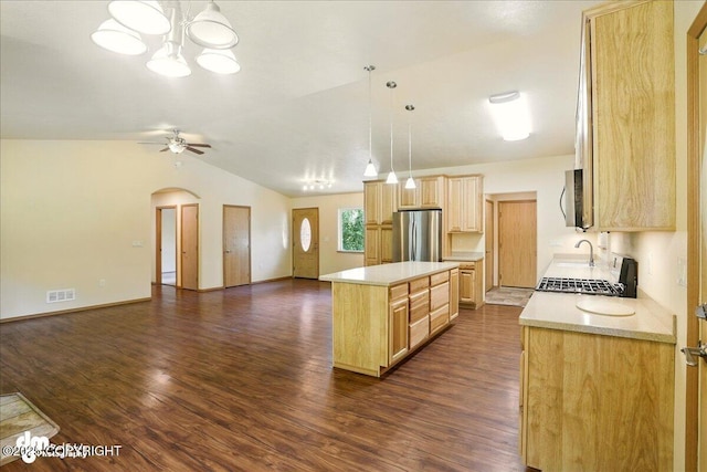 3963 N Coronado St, Wasilla, AK 99623 - kitchen with stainless steel appliances, light brown cabinetry, light countertops, open floor plan, and lofted ceiling