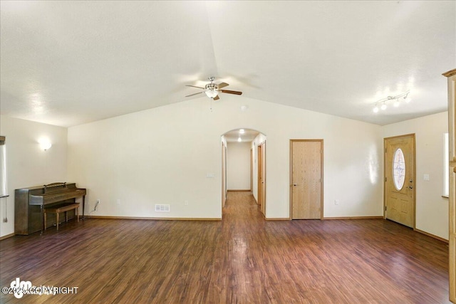 3963 N Coronado St, Wasilla, AK 99623 - unfurnished living room featuring arched walkways, a ceiling fan, wood finished floors, and lofted ceiling