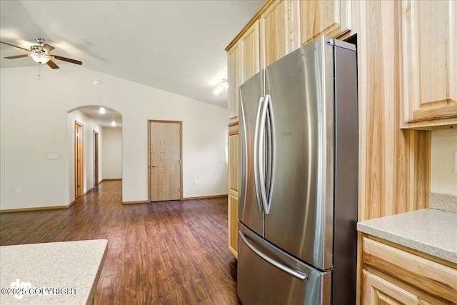 3963 N Coronado St, Wasilla, AK 99623 - kitchen featuring freestanding refrigerator, light brown cabinets, arched walkways, ceiling fan, and lofted ceiling