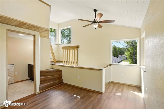 3963 N Coronado St, Wasilla, AK 99623 - unfurnished room with wood finished floors, a ceiling fan, lofted ceiling, and stairway