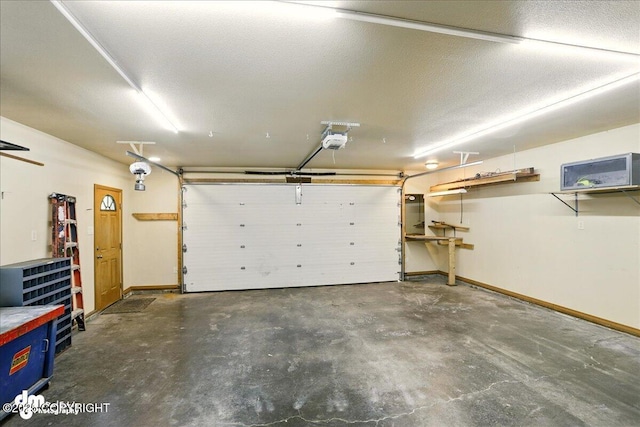 3963 N Coronado St, Wasilla, AK 99623 - garage featuring a garage door opener and baseboards