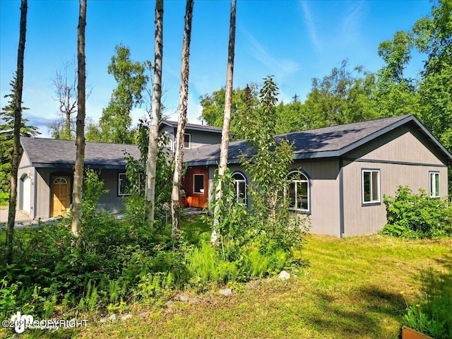 3963 N Coronado St, Wasilla, AK 99623 - rear view of property with roof with shingles and a yard