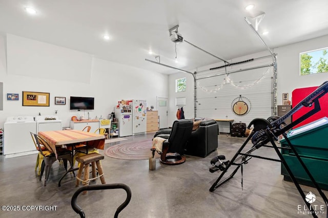 6961 S Hangar Talk Cir, Wasilla, AK 99623 - garage with separate washer and dryer, a garage door opener, freestanding refrigerator, and recessed lighting