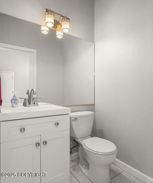 2551 Lahonda Dr, Anchorage, AK 99517 - half bath featuring baseboards, toilet, and vanity