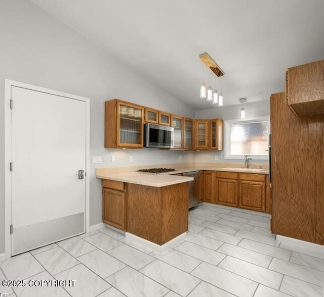 2551 Lahonda Dr, Anchorage, AK 99517 - kitchen featuring stainless steel appliances, brown cabinets, a peninsula, a sink, and light marble finish floors