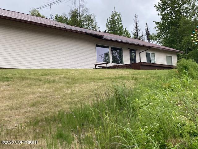 50470 Maranatha Ln, Nikiski/North Kenai, AK 99611 - rear view of property with a metal roof and a lawn