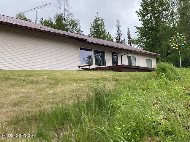 50470 Maranatha Ln, Nikiski/North Kenai, AK 99611 - rear view of property featuring a metal roof and a yard