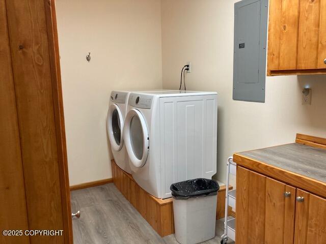 50470 Maranatha Ln, Nikiski/North Kenai, AK 99611 - washroom with electric panel, cabinet space, light wood-type flooring, and independent washer and dryer