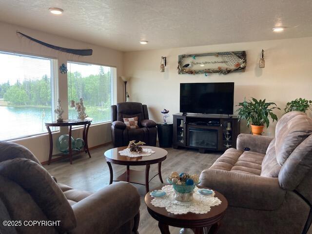 50470 Maranatha Ln, Nikiski/North Kenai, AK 99611 - living room with light wood-type flooring, a textured ceiling, and recessed lighting