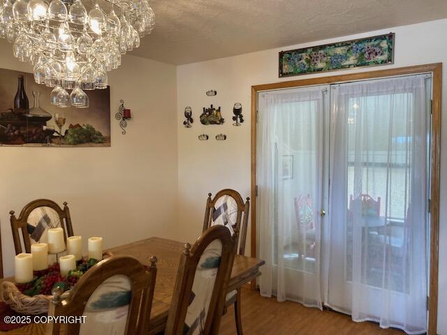 50470 Maranatha Ln, Nikiski/North Kenai, AK 99611 - dining space with light wood-style flooring and a chandelier