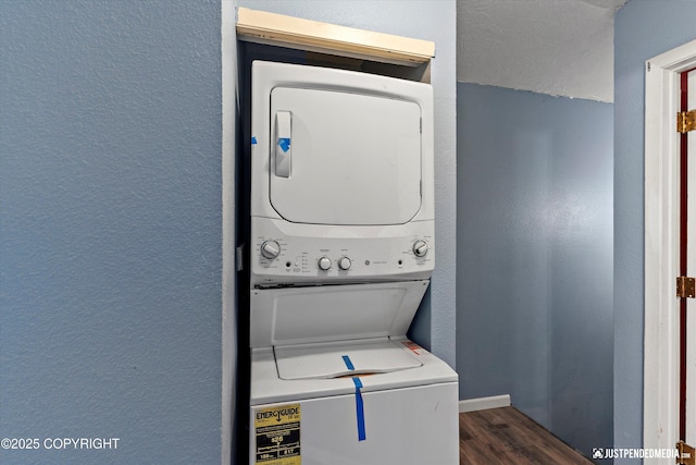 1711 Russian Jack Dr # B4, Anchorage, AK 99508 - laundry area featuring stacked washing machine and dryer, wood finished floors, and a textured wall