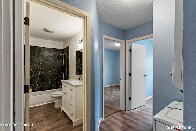 1711 Russian Jack Dr # B4, Anchorage, AK 99508 - full bath with vanity, wood finished floors, shower / bath combination, a textured ceiling, and washer / dryer
