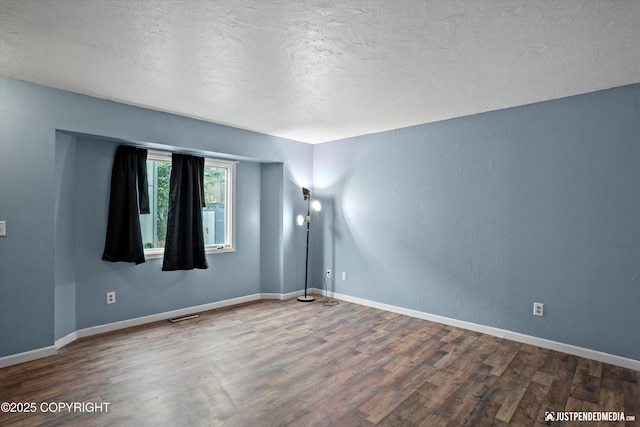 1711 Russian Jack Dr # B4, Anchorage, AK 99508 - spare room with wood finished floors and a textured ceiling