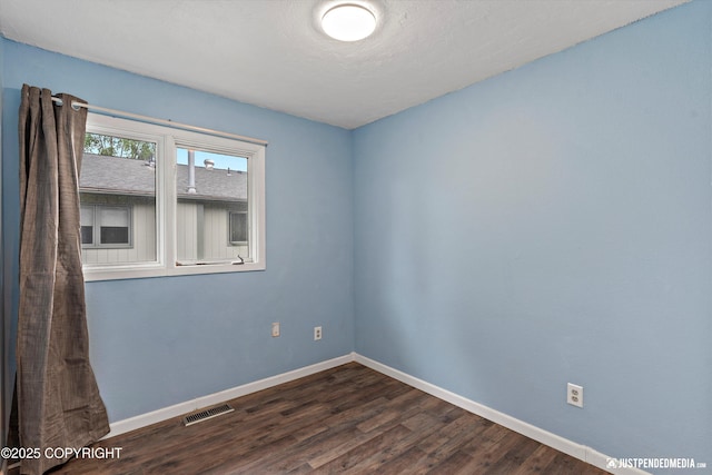 1711 Russian Jack Dr # B4, Anchorage, AK 99508 - unfurnished room featuring baseboards and dark wood-style flooring