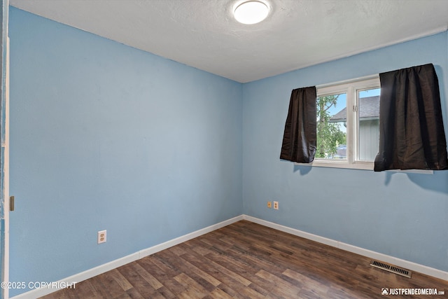 1711 Russian Jack Dr # B4, Anchorage, AK 99508 - spare room with baseboards and dark wood-style flooring