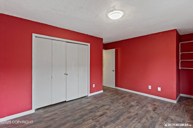 1711 Russian Jack Dr # B4, Anchorage, AK 99508 - unfurnished bedroom with wood finished floors, a closet, and a textured ceiling