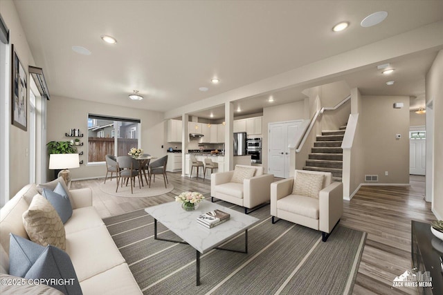 2987 Morgan Loop, Anchorage, AK 99516 - living room featuring light wood-type flooring, stairs, healthy amount of natural light, and recessed lighting