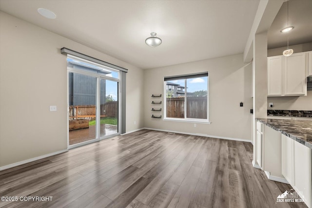 2987 Morgan Loop, Anchorage, AK 99516 - unfurnished dining area featuring wood finished floors and baseboards