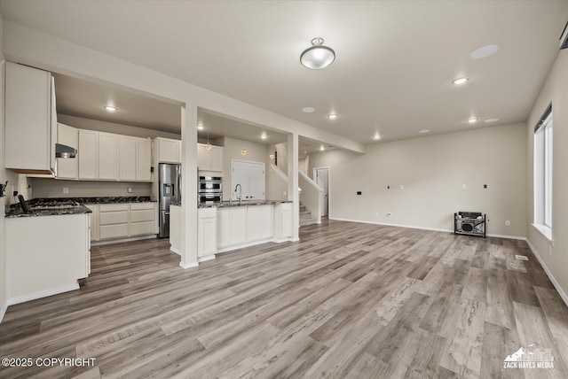 2987 Morgan Loop, Anchorage, AK 99516 - unfurnished living room featuring recessed lighting, light wood finished floors, and stairway