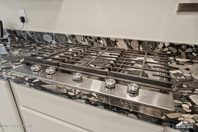 2987 Morgan Loop, Anchorage, AK 99516 - kitchen view of stainless steel gas cooktop, dark countertops, and decorative backsplash