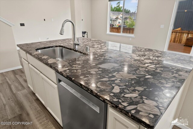 2987 Morgan Loop, Anchorage, AK 99516 - kitchen featuring stainless steel dishwasher, light wood-style floors, dark stone counters, and white cabinets