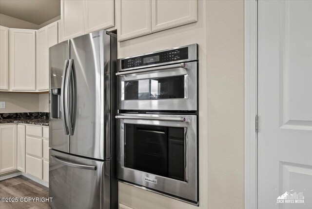 2987 Morgan Loop, Anchorage, AK 99516 - kitchen with stainless steel appliances, white cabinets, wood finished floors, and dark stone countertops
