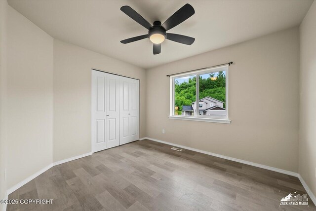 2987 Morgan Loop, Anchorage, AK 99516 - unfurnished bedroom featuring wood finished floors, a closet, and ceiling fan