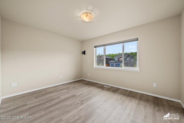 2987 Morgan Loop, Anchorage, AK 99516 - spare room with wood finished floors and baseboards
