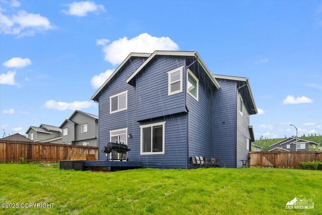 2987 Morgan Loop, Anchorage, AK 99516 - back of house featuring a fenced backyard and a wooden deck