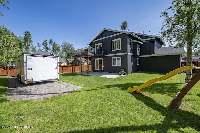 13378 Rosser Dr, Eagle River, AK 99577 - rear view of house with a patio, a playground, a fenced backyard, and a storage shed